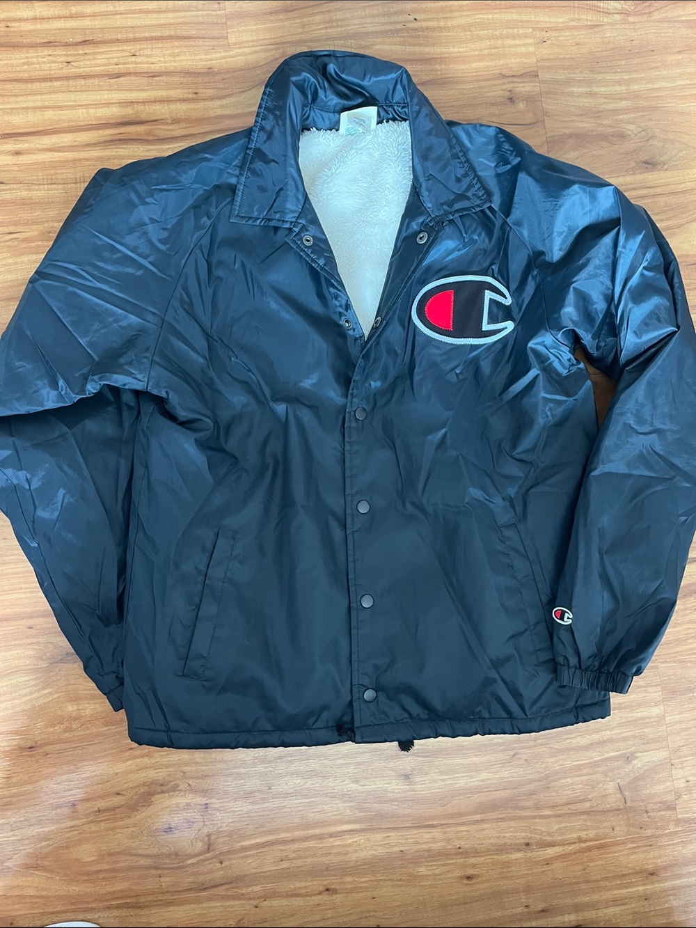 Champion Black Coach Jacket with White Sherpa Lining and Red Logo